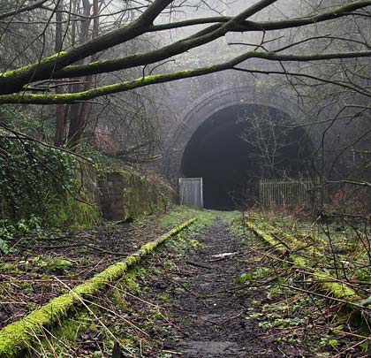 The north portal is approached through a deep cutting, with small retaining walls at the toe of the slopes.
