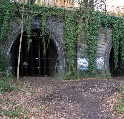 The ivy-covered brick-built eastern portals of Highgate East Tunnel.