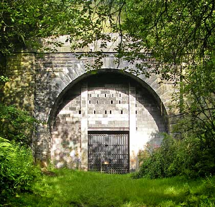 Now fortress-like, the substantial east portal is stone-built with buttresses on both sides of the entrance.