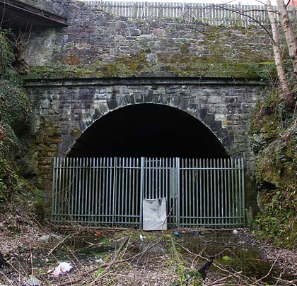 The south portal, which lurks beneath a road, has lost some of its headwall due to a lack of maintenance.