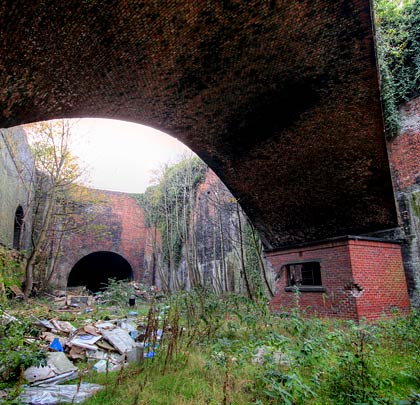 The east portal forms the end wall of an open box, spanned by a single-arched brick bridge, where wagons were marshalled.