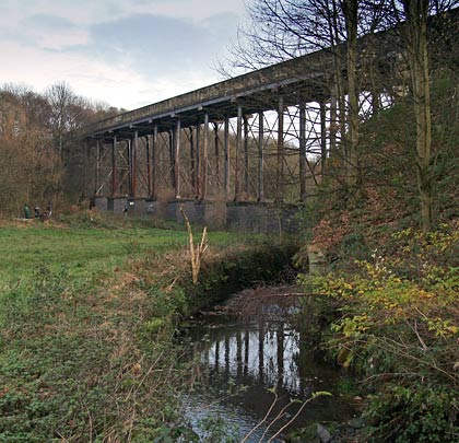 The viaduct's western span carries the approach road over a beck.