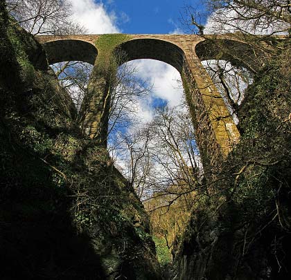 The narrow Den is conquered by a viaduct of just three 40-foot arches, together with a single smaller side-span.