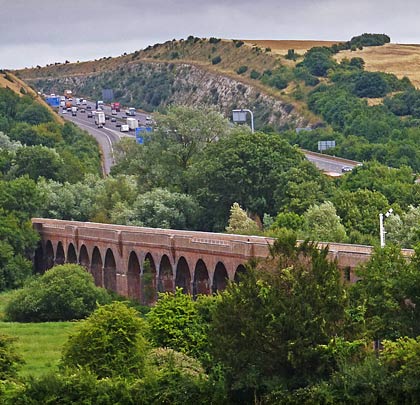 The viaduct runs parallel with the M3 but is masked from it by trees.