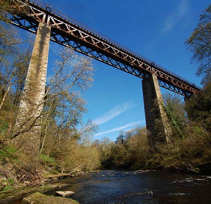 A riverside view conveying the height of the viaduct: at 175 feet, it's the highest in Scotland to carry a railway.