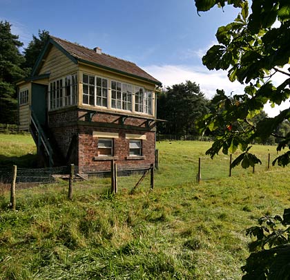 The signal box sitting in splendid isolation in a field.
