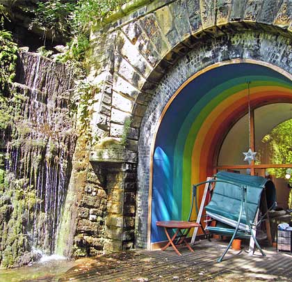 Sunlight and a rainbow brighten the portal at the south end.