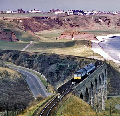 A green-blue liveried Swindon DMU heads west on the 13th April 1968, affording passengers a wonderful view of the coastline.