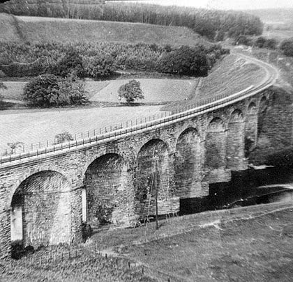 The line scurries over the viaduct and disappears towards Langholm.