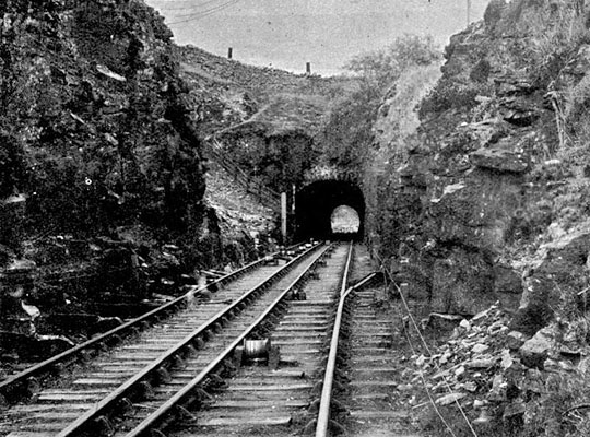 Interlaced tracks descend the incline towards the tunnel.