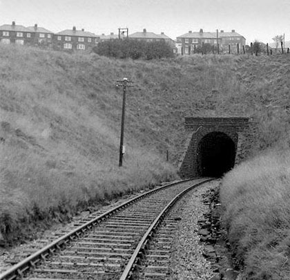 A telegraph pole stands sentinel at the south portal of the tunnel.