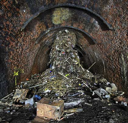Accumulating in the tunnel is a vast column of detritus, tipped down the shaft and now extending up it.