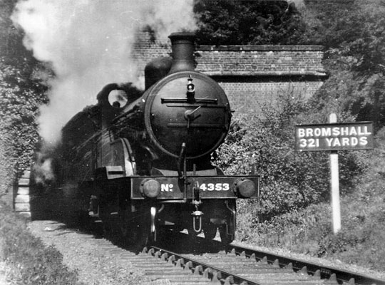 Locomotive 4353 bursts out of the ivy-covered south portal.