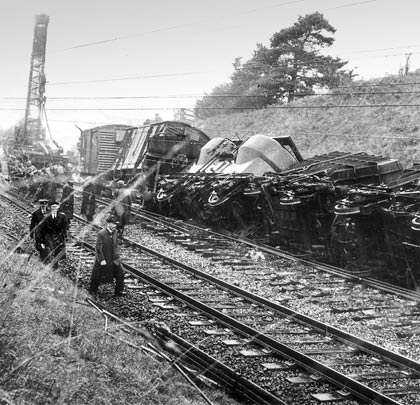 In September 1965, investigators sift through the wreckage of a violent derailment close to the viaduct.