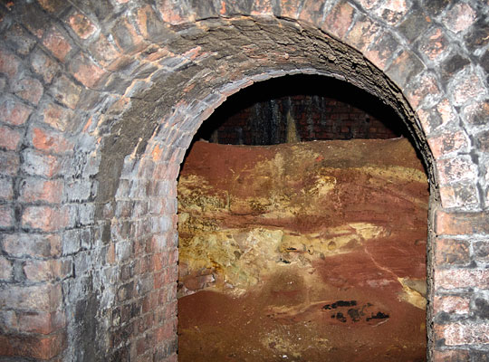 An arched opening in the south-east sidewall of No.3 tunnel leads to a partially-excavated second bore.
