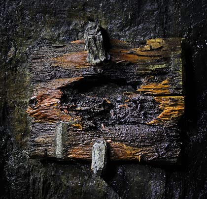 The remains of a wooden tablet still clings to the east side wall.