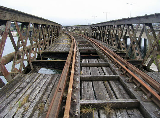 Captured in 2009, the bridge's decaying deck timbers and rusting single track.