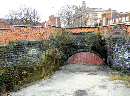 The bricked-up north portal of Woodside Tunnel.