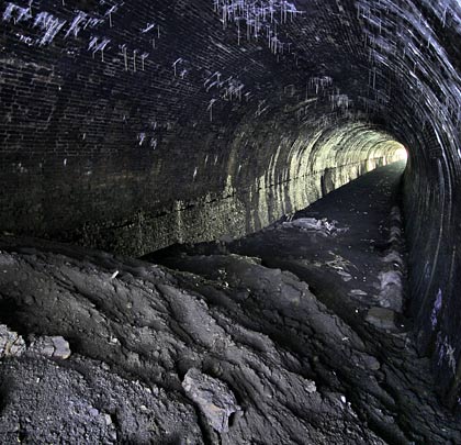 Although initially straight, the tunnel incorporates a gentle curve to the south towards its western end.