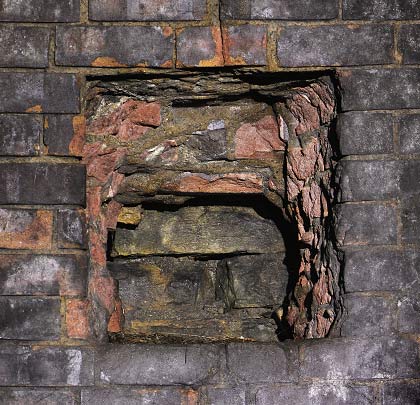 A hole cut in the brickwork suggests that the original lining was built in masonry, with a secondary brick lining added at a later date.