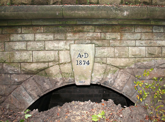 The portal's exposed keystone bearing the line's opening date of 1874.
