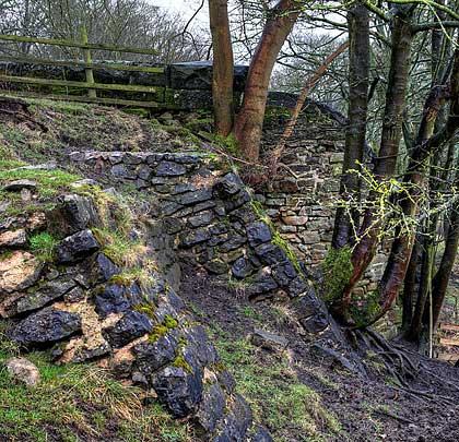 Buttresses provide support to the west side wall near the portal.