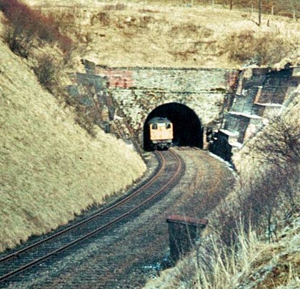 On 1st April 1970, just over a year after the line had closed, an engineer's special pokes its nose out of the south portal.
