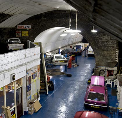 A garage now fills the area once occupied by the trackbed, platforms and station buildings.