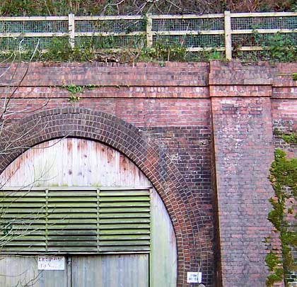 The tidy portal reveals an arch of five brick rings and buttresses to either side of the entrance.