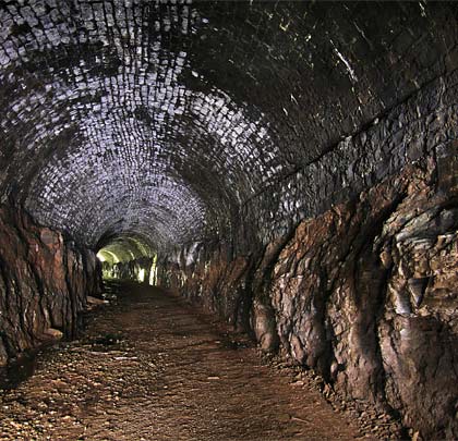 For much of its length, the tunnel - curving to the east throughout - features a masonry arch springing off shelves cut into the rock.