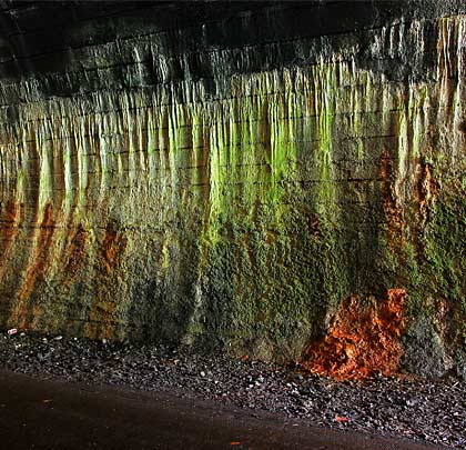 Inside, the tunnel has suffered from significant localised water penetration, resulting in extensive calcite deposits on the sidewalls.