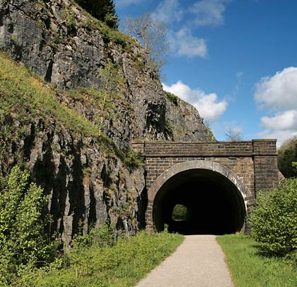 Between Millers Dale Station and junction, the main line across the Peaks passed through some remarkable limestone scenery and the 120-yard Rusher Cutting Tunnel.
