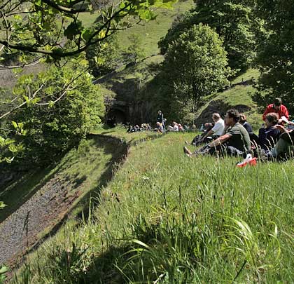 Picnickers enjoy the view of Water-cum-Jolly Dale in the Peaks, 90 feet above the River Wye. They're sitting on an artificial ledge, built to carry the main line between Cressbrook and Litton tunnels.