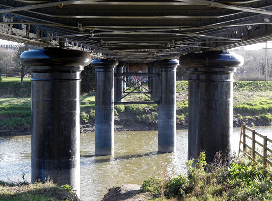 The piers comprise pairs of concrete-filled cylinders, 5 feet in diameter.