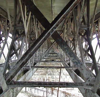The intricate lattice of ironwork slowly decays.