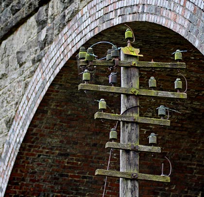 Sheltering beneath one of the brick arches is a relic of the S&D's former telegraph system.