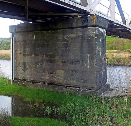 Two rectangular concrete piers stand on opposite banks.