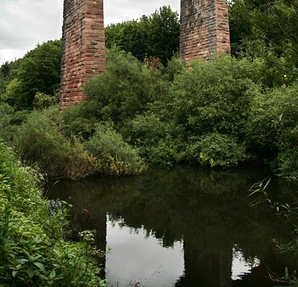 Two piers reflect in the River Till.