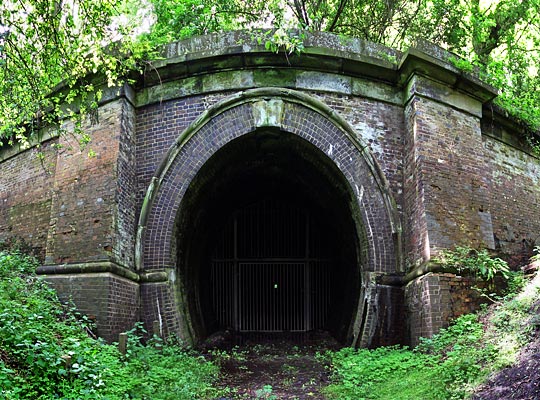 The classic south portal is predominantly built in brick, but has stone detailing such as the parapet, keystone and arch oversail.