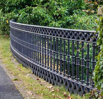 Decorative cast-iron railings form the curved parapet.