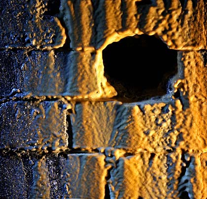 Holes have been cut to allow water to drain from behind the lining. This has resulted in mineral deposits adorning the brickwork.