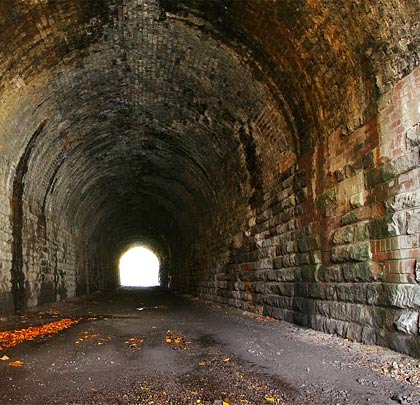 As built, the tunnel featured vertical masonry sidewalls and a brick arch, but repair work to the walls has seen brickwork inserted where the stone faces have been lost to time and water penetration.