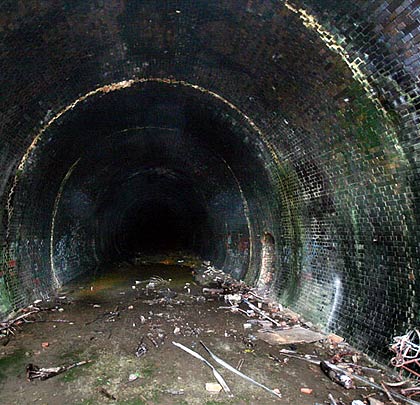 The brick-lined tunnel is wet close to the portal.