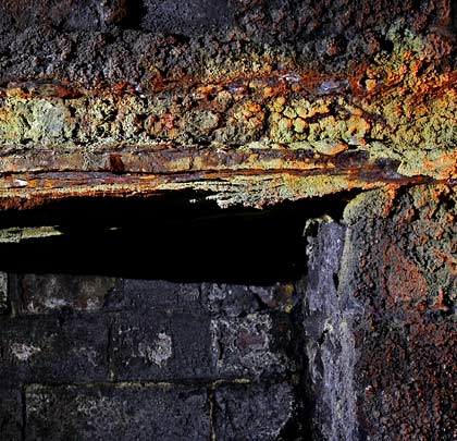 Slowly decaying, a girder puts on a colourful display whilst acting as a lintel above one of the refuges.