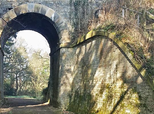 At its north-east end, an elegant skewed arch with large stone voussoirs is pushed through the abutment to accommodate a track.