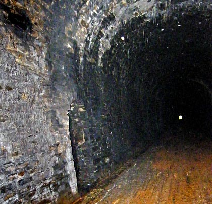 The single bore tunnel has cultivated a collection of short stalactites.