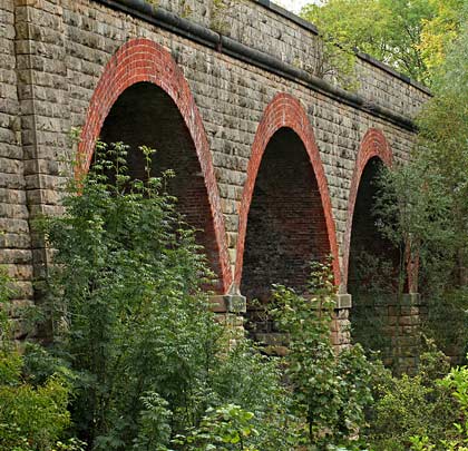 Whilst most of the structure is built from rock-faced stone, the arches are formed of six red brick rings.