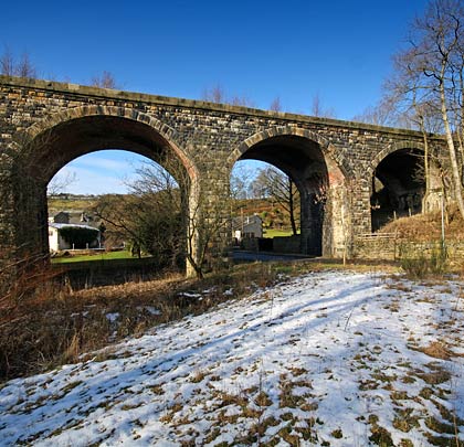 The viaduct features nine segmental arches - above which there seems to be very little cover - and a low parapet wall.