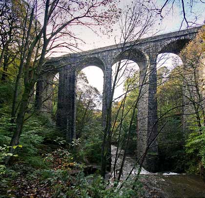 Healey Dell Viaduct carried trains 105 feet above the River Spodden on eight arches - three of them skewed - built of locally quarried stone. Opened in 1870, the line over it survived for 97 years.