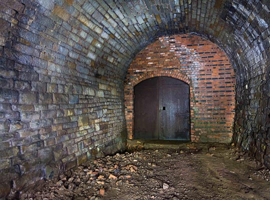 A short distance into the tunnel is a brick blockwall with double steel gates.